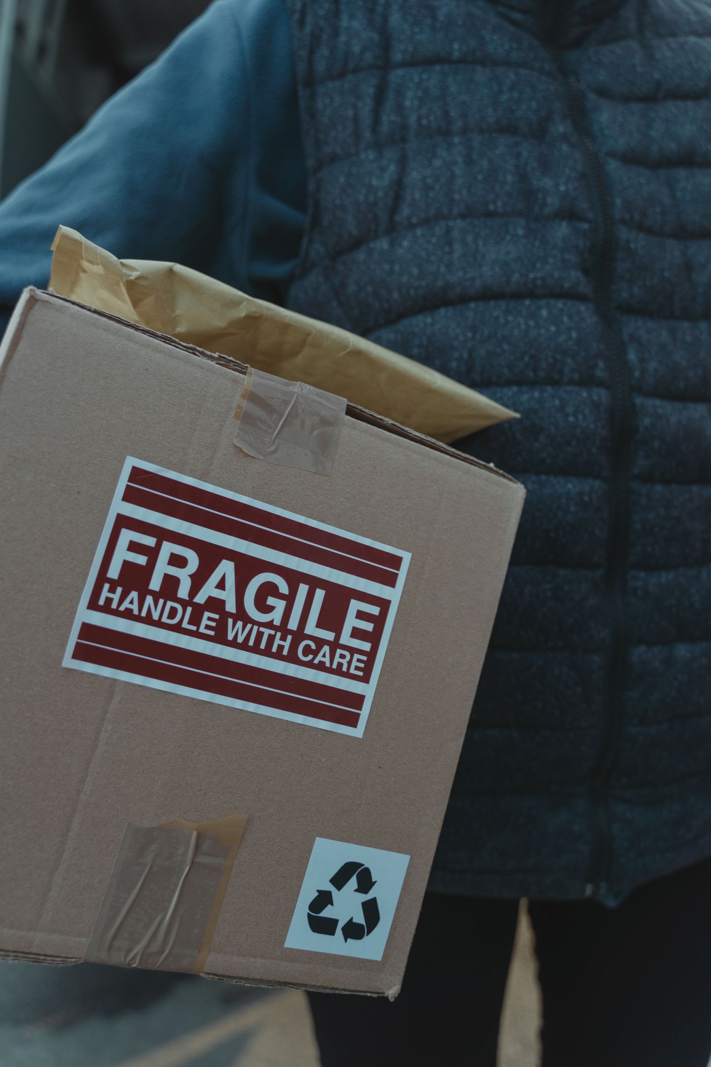 Hands closing a carton